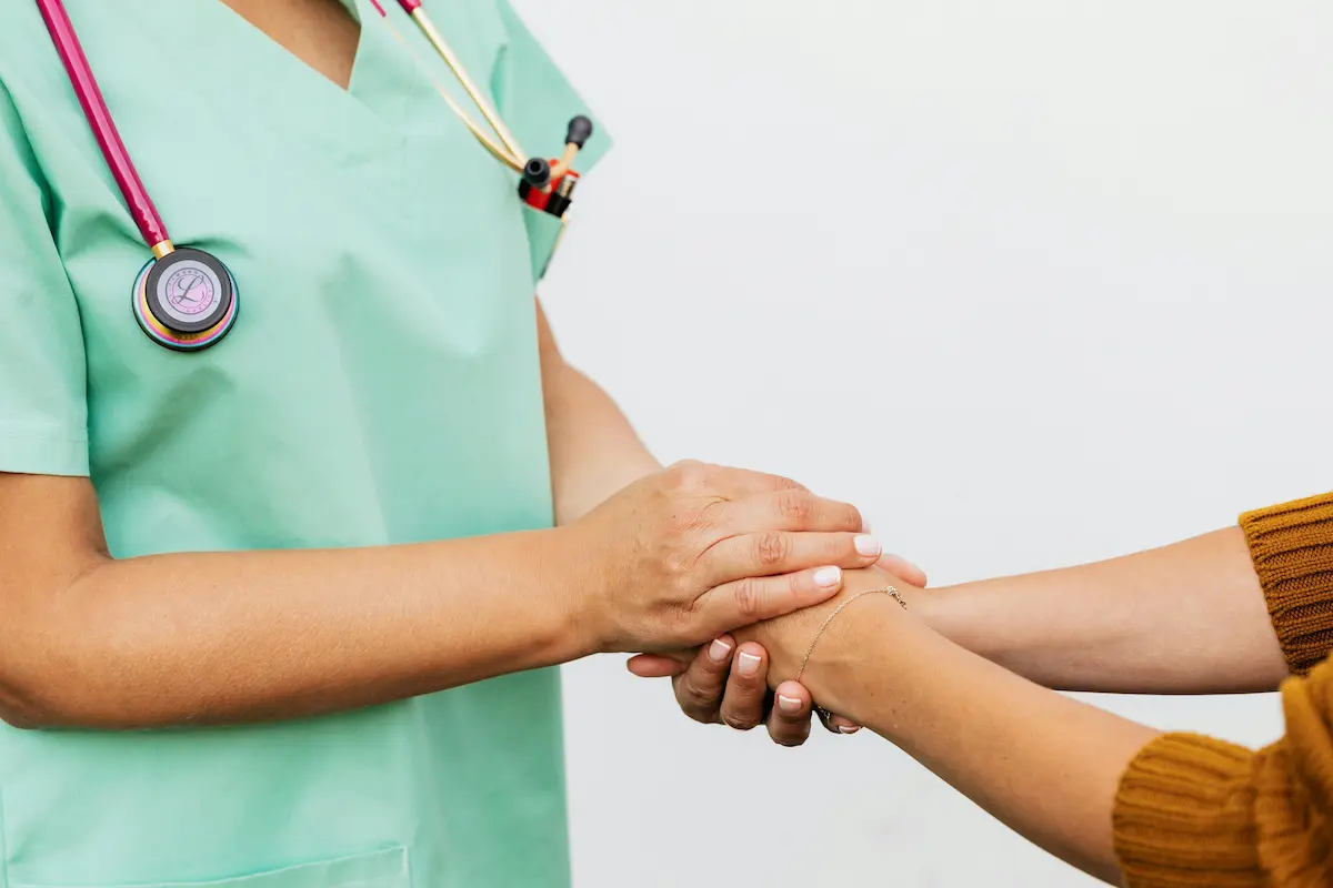 Registered nurse holding a patients hands and providing companionship and care in their Belleville home.