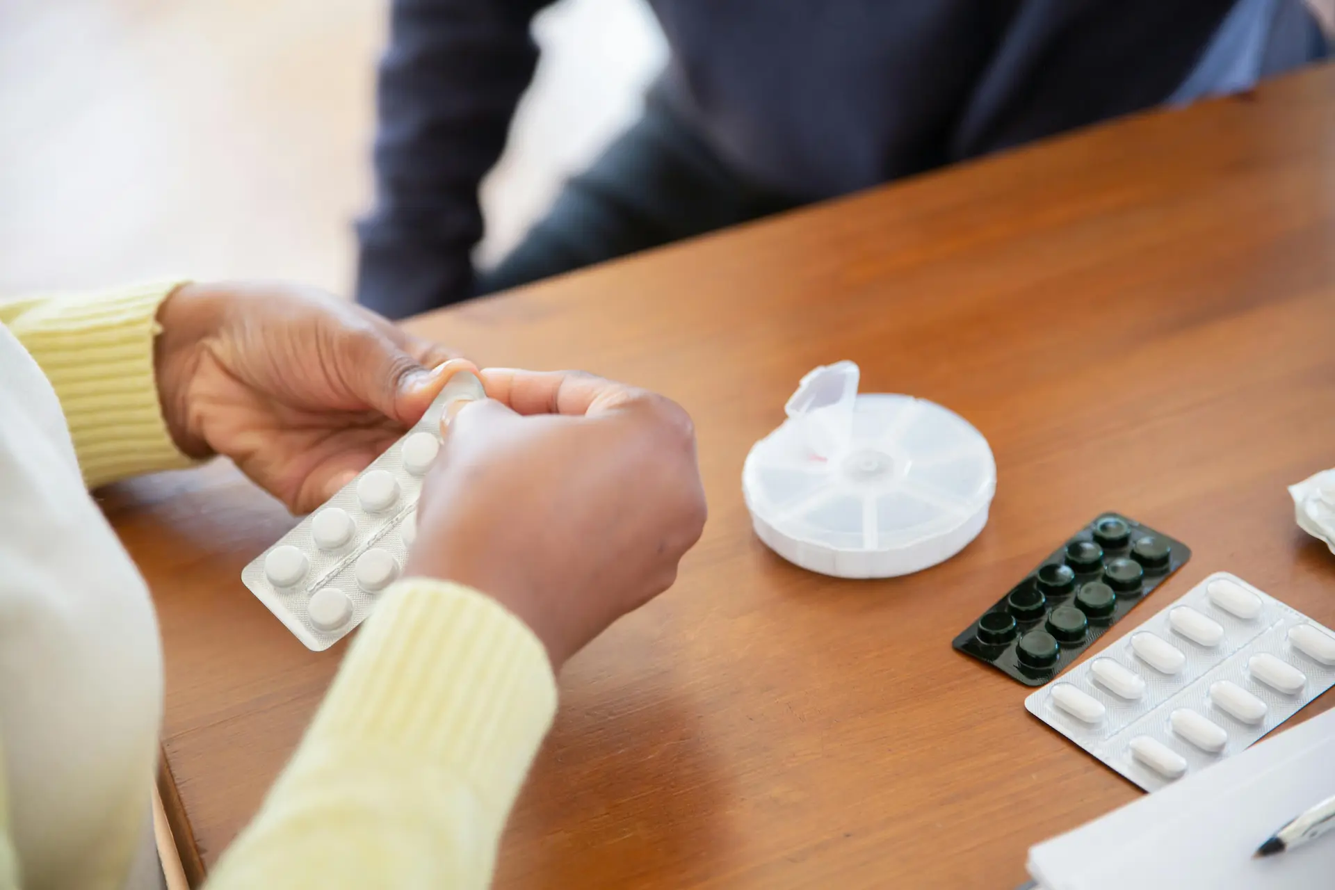 Registered nurse reviewing a patient's medication chart and pill box in their Belleville home. Providing expert medication management and support.