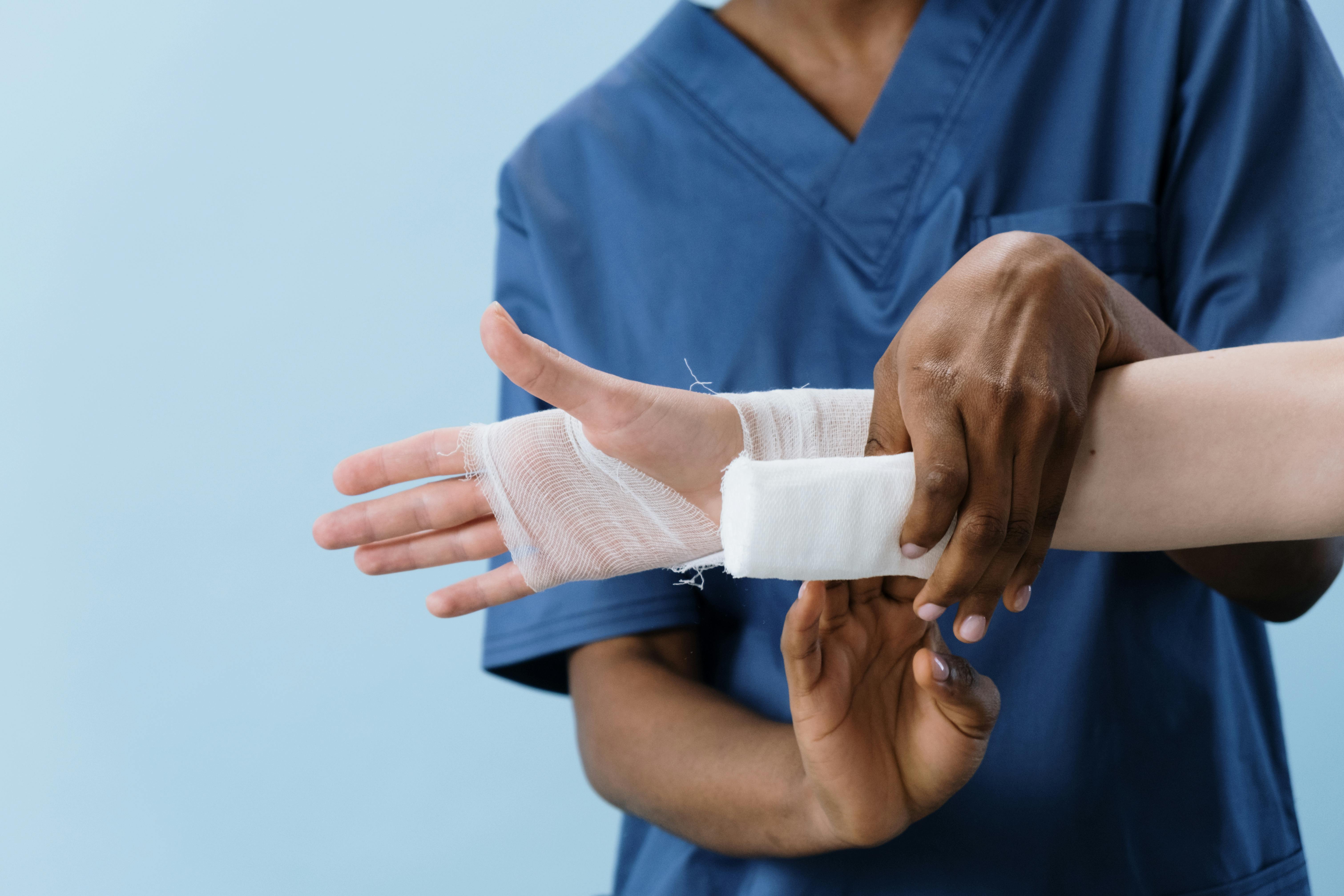Registered nurse checking a patient's pulse and reviewing chart in a home setting